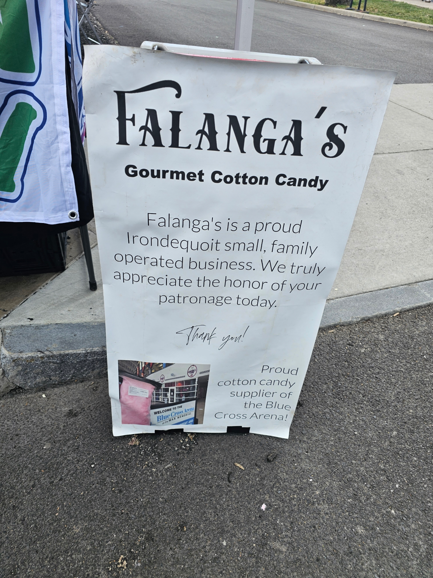 Falanga's Gourmet Cotton Candy sandwich-board sign noting they're a proud supplier of the Blue Cross Arena