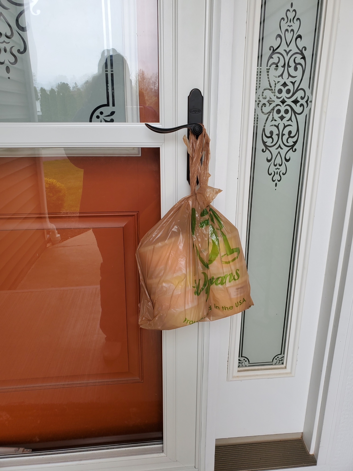 Contact-free Falanga's cotton candy delivery hanging from a front door handle