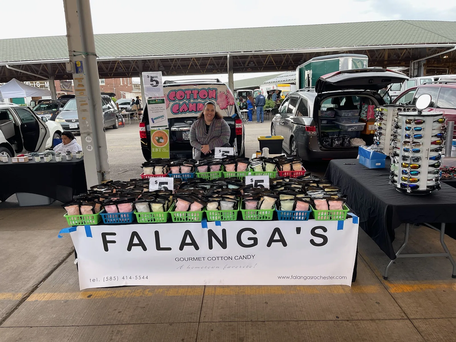 Falanga's full table spread of cotton candy bags at the Rochester Public Market