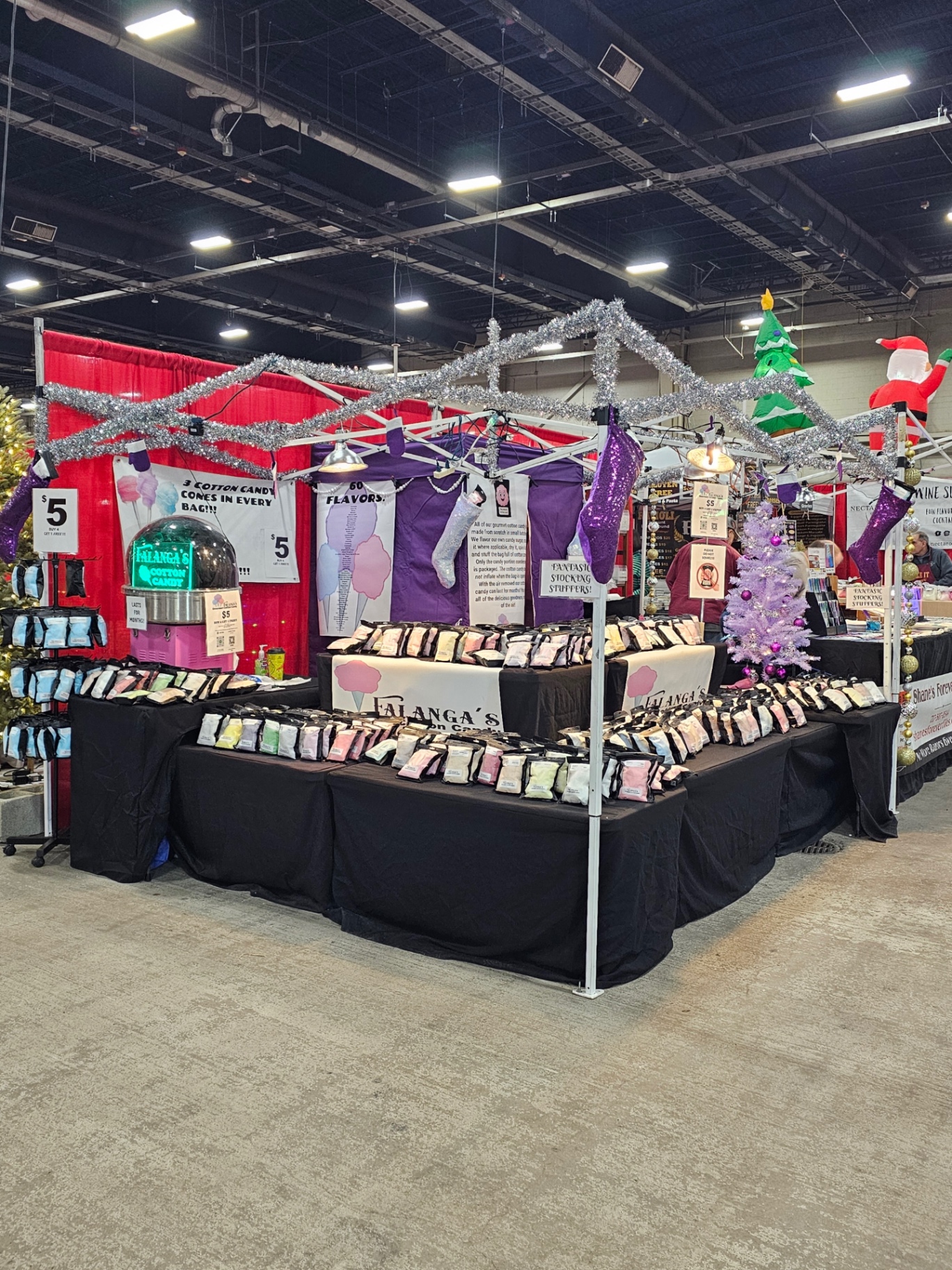 Falanga's booth decorated for the holidays at an indoor Christmas market