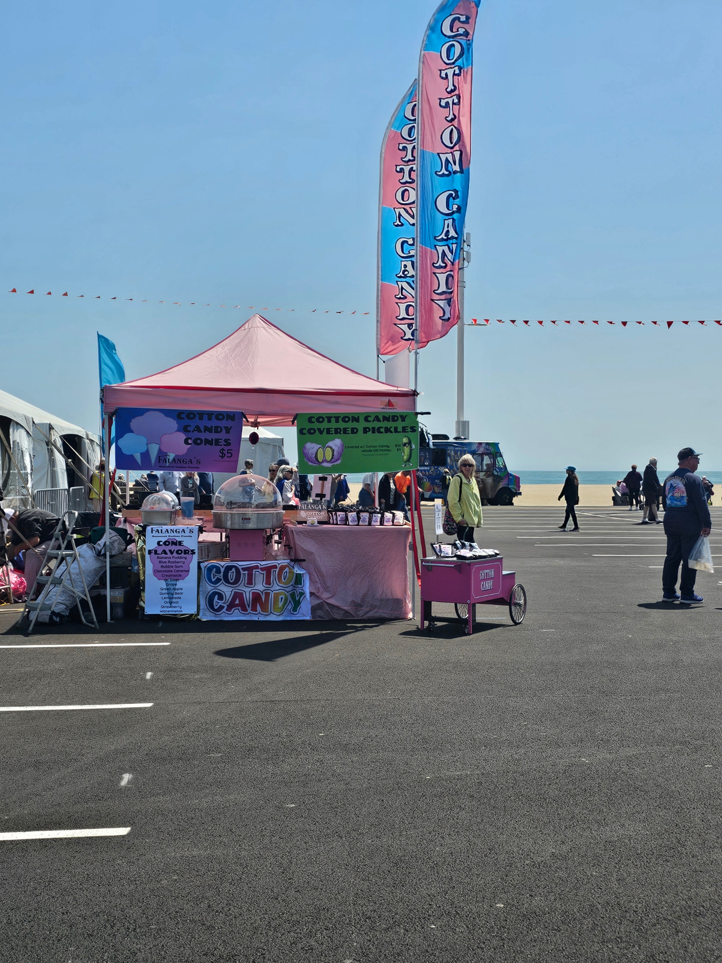 Falanga's Cotton Candy cart and tent at a beachside boardwalk event