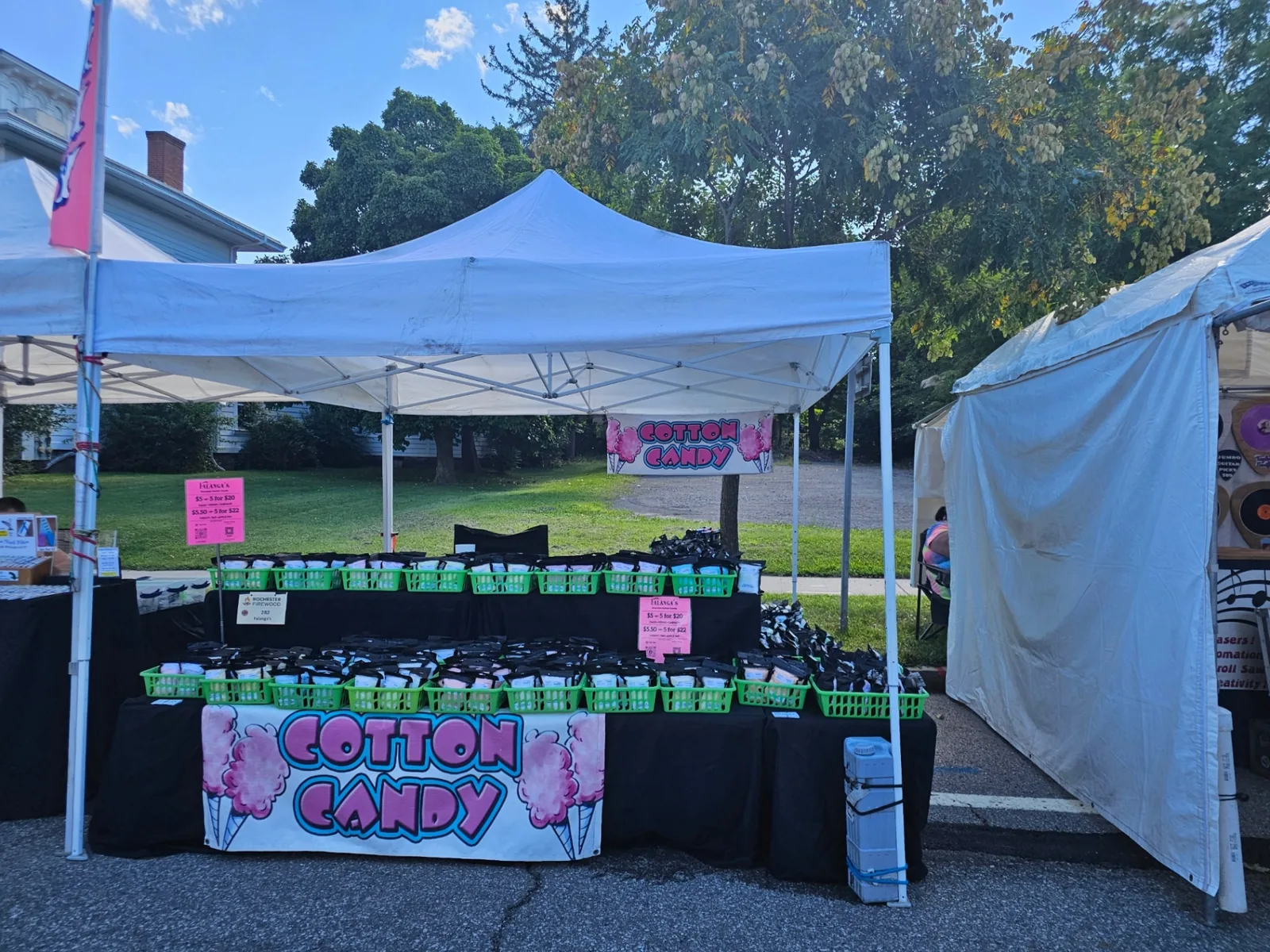 Falanga's tent with full cotton candy display and banner at a Rochester street festival