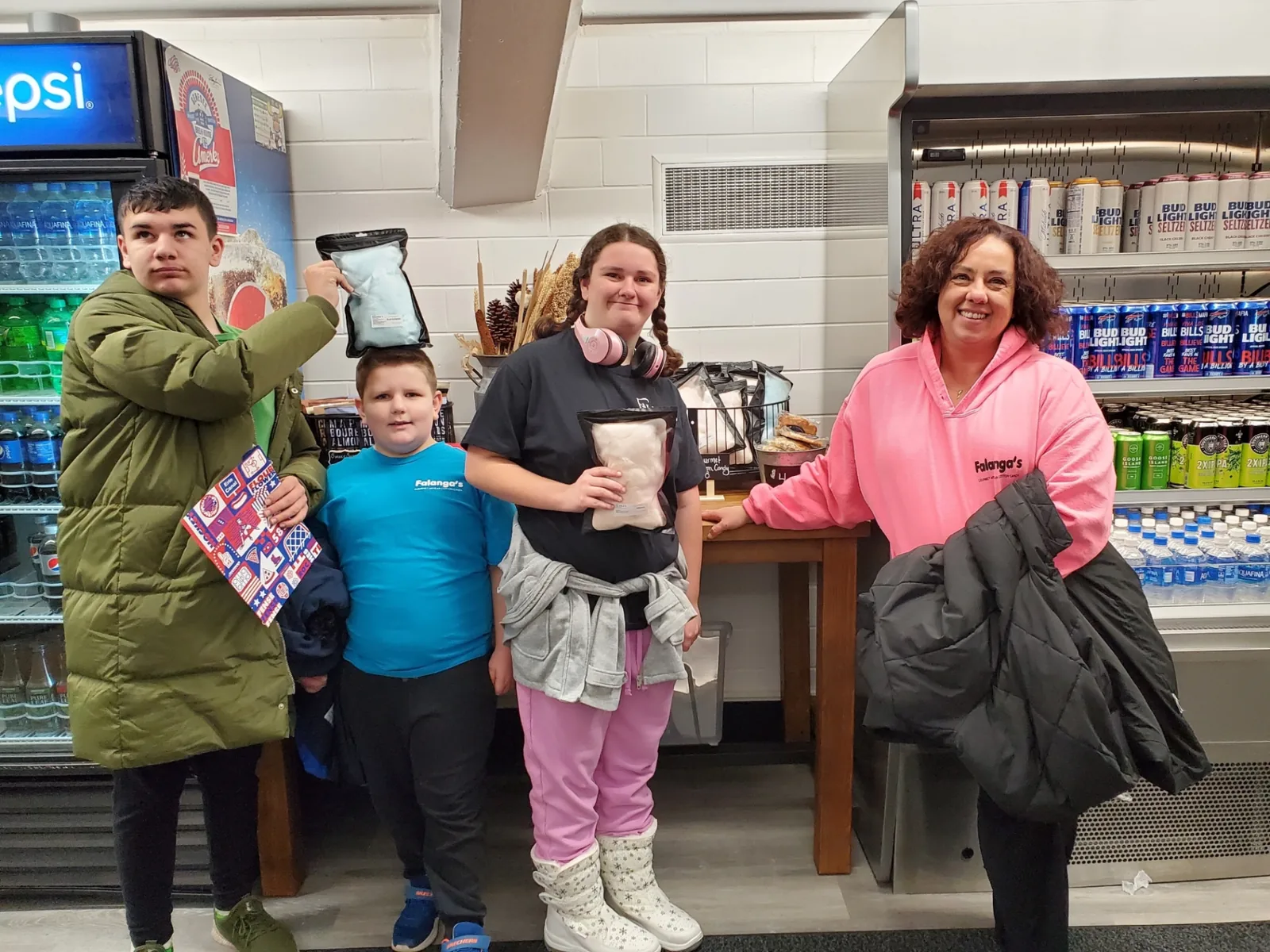 Customer family picking up cotton candy bags from Falanga's at a local stop